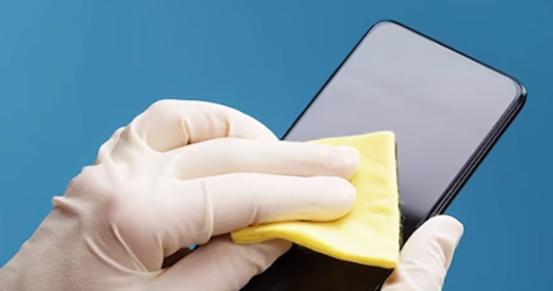  A clean and shiny smartphone screen being wiped with a microfiber cloth.